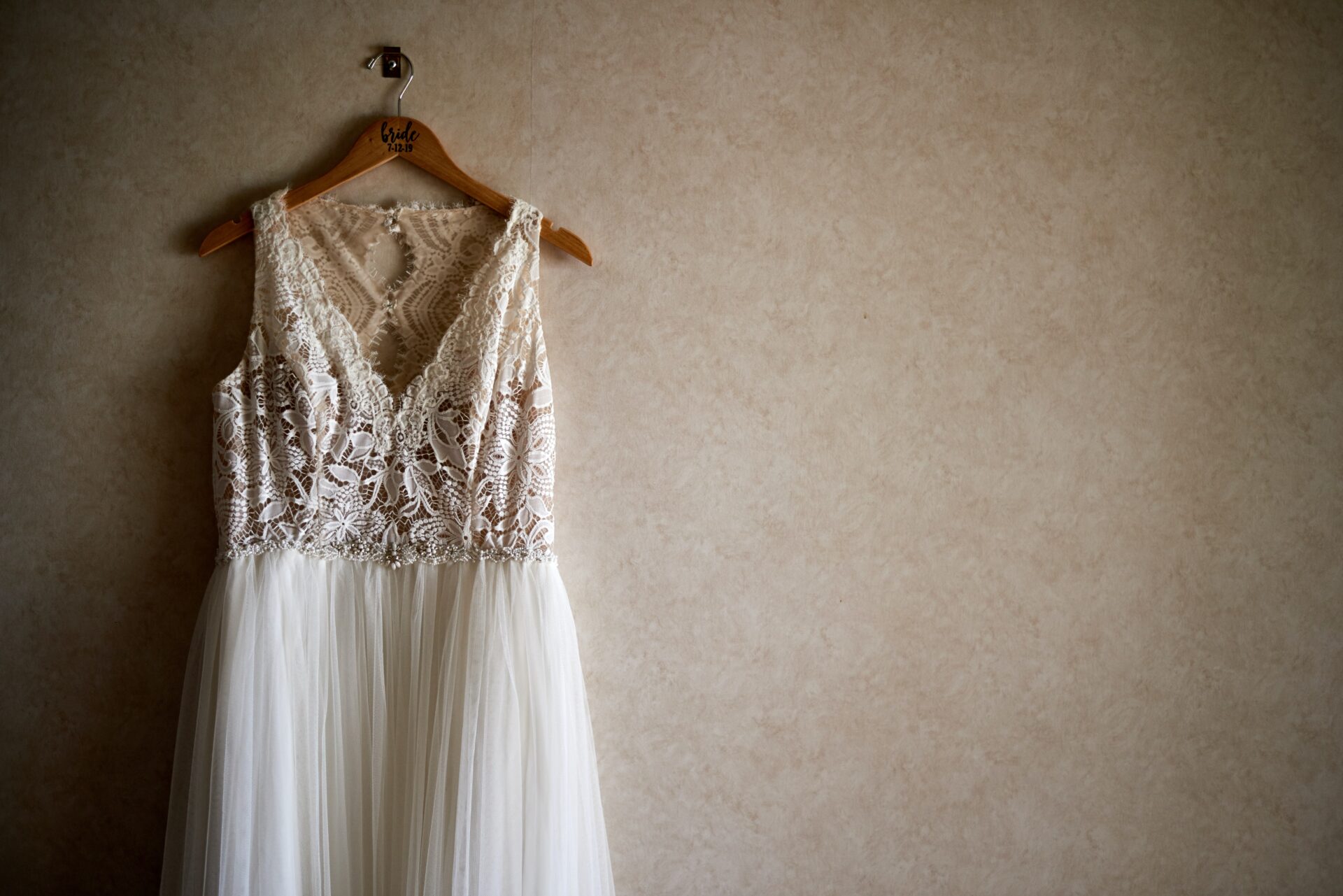 a sleeveless bridal dress on a hanger