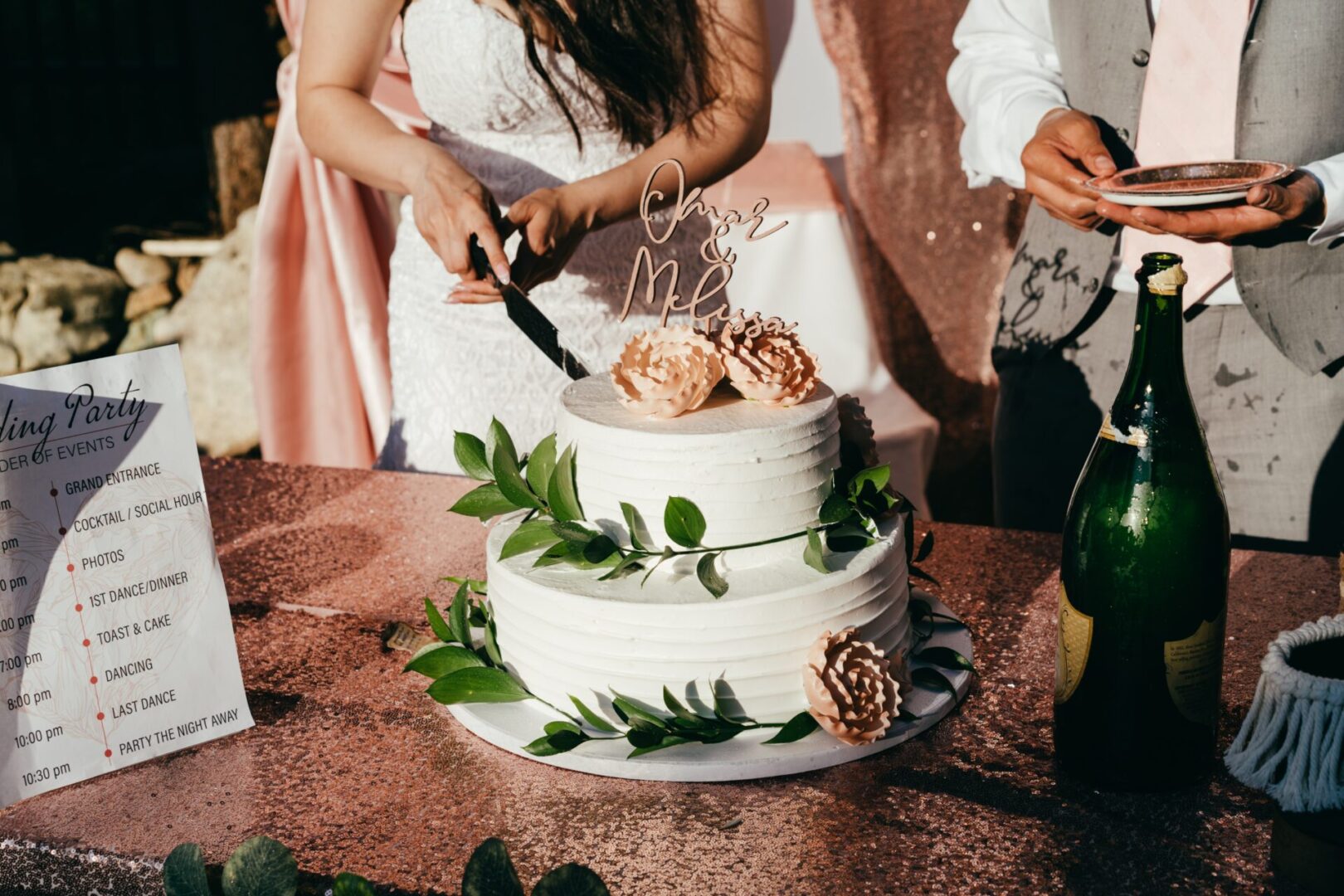 a bride cutting her wedding cake for serving