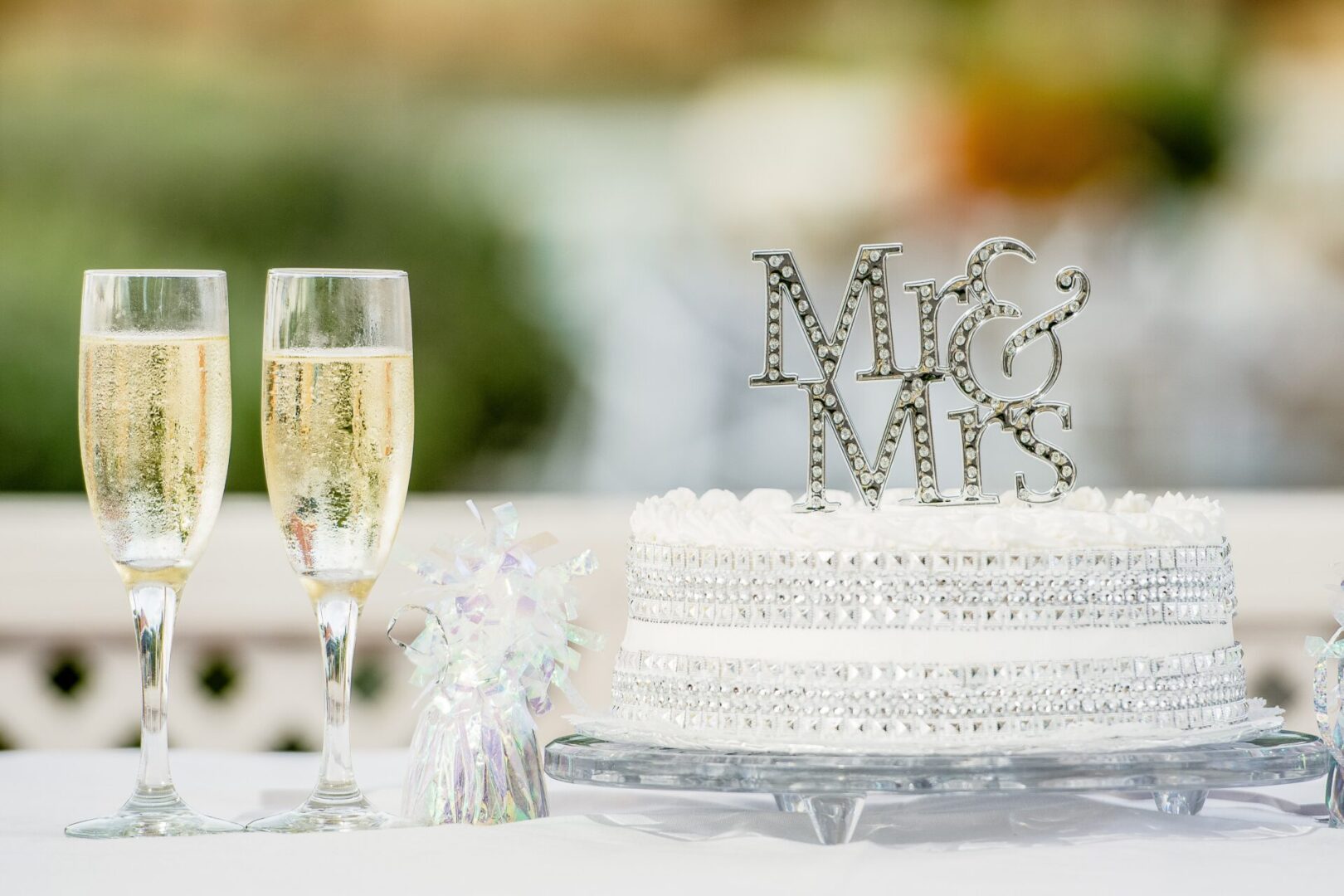 a Mr. and Mrs. Cake with two glasses of Champagne