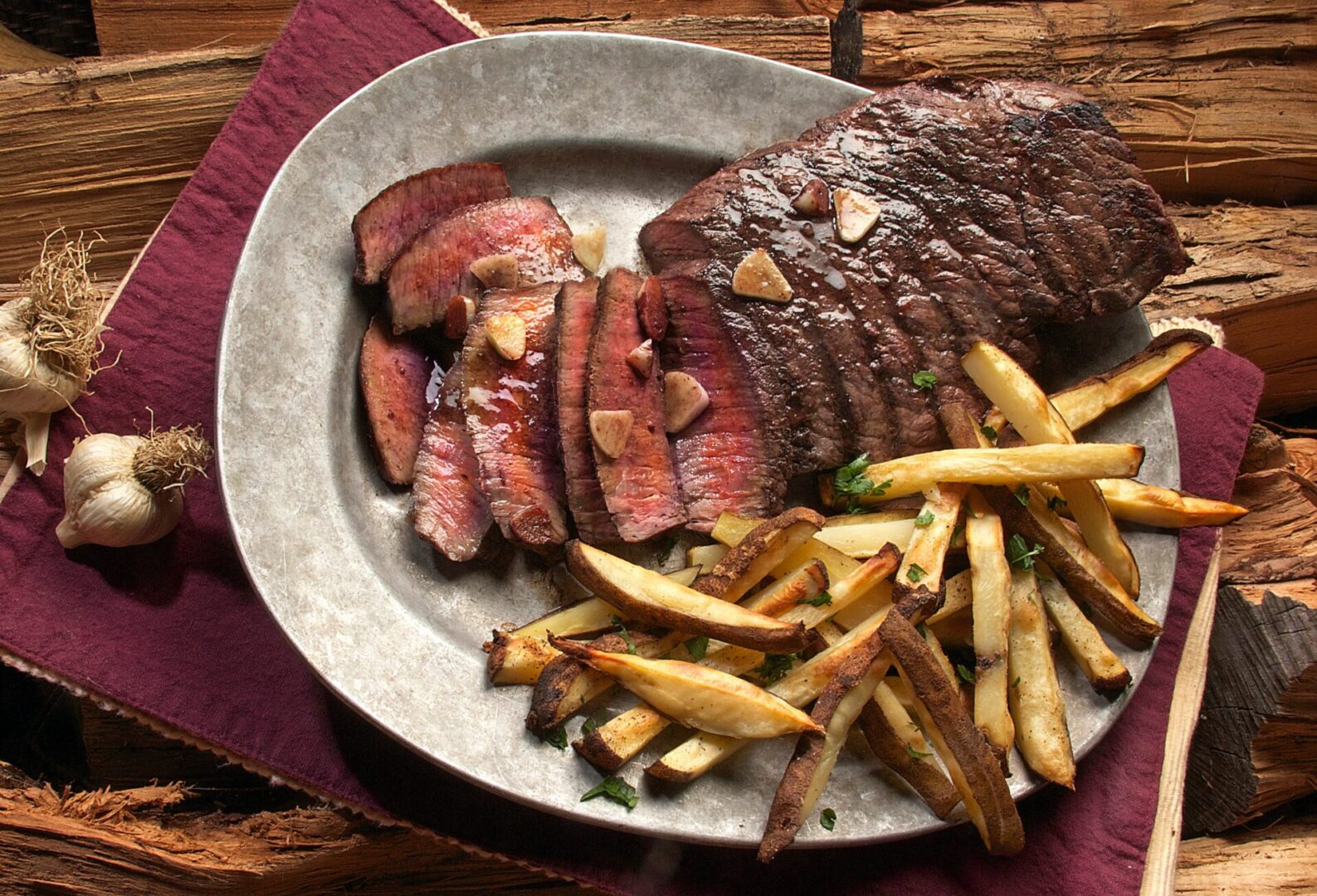 Steak frites, and two garlic placed besides it