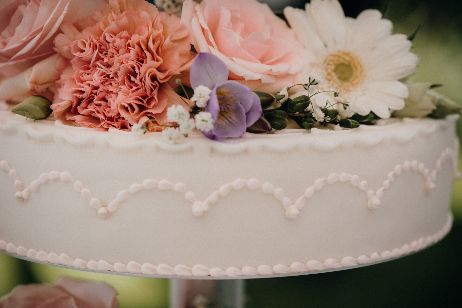 Close up of wedding cake with flowers on it