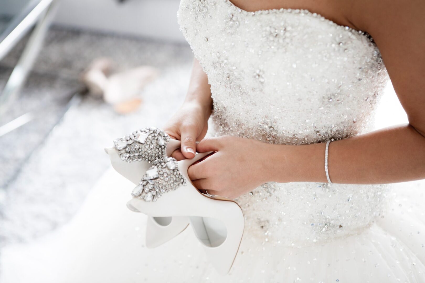 Close up of bride's shoes in her hand